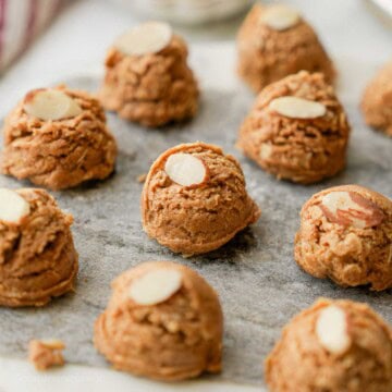 Almond butter protein bite on marble with almond slice.
