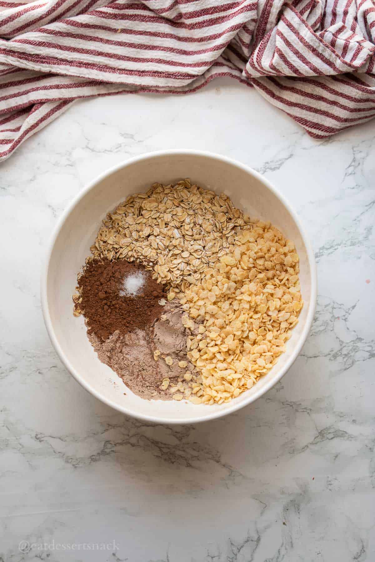 Oats, cocoa powder, protein powder in bowl.