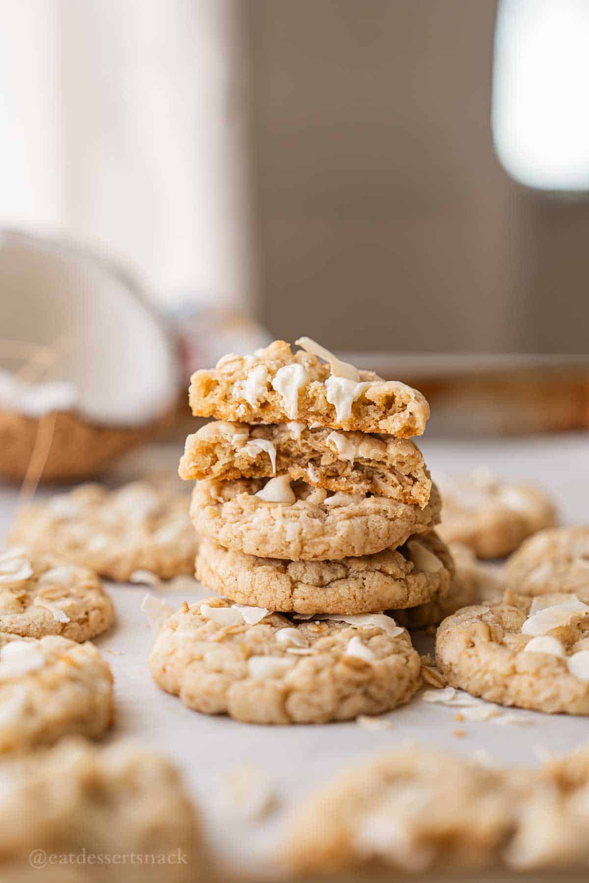 Stacked oatmeal cookies on baking tray.