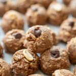 Chocolate peanut butter balls stacked on tray.