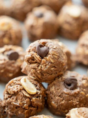Chocolate peanut butter balls stacked on tray.