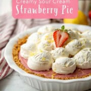 Baked strawberry pie with whipped cream on top.