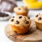 Baked banana protein muffin on cutting board.