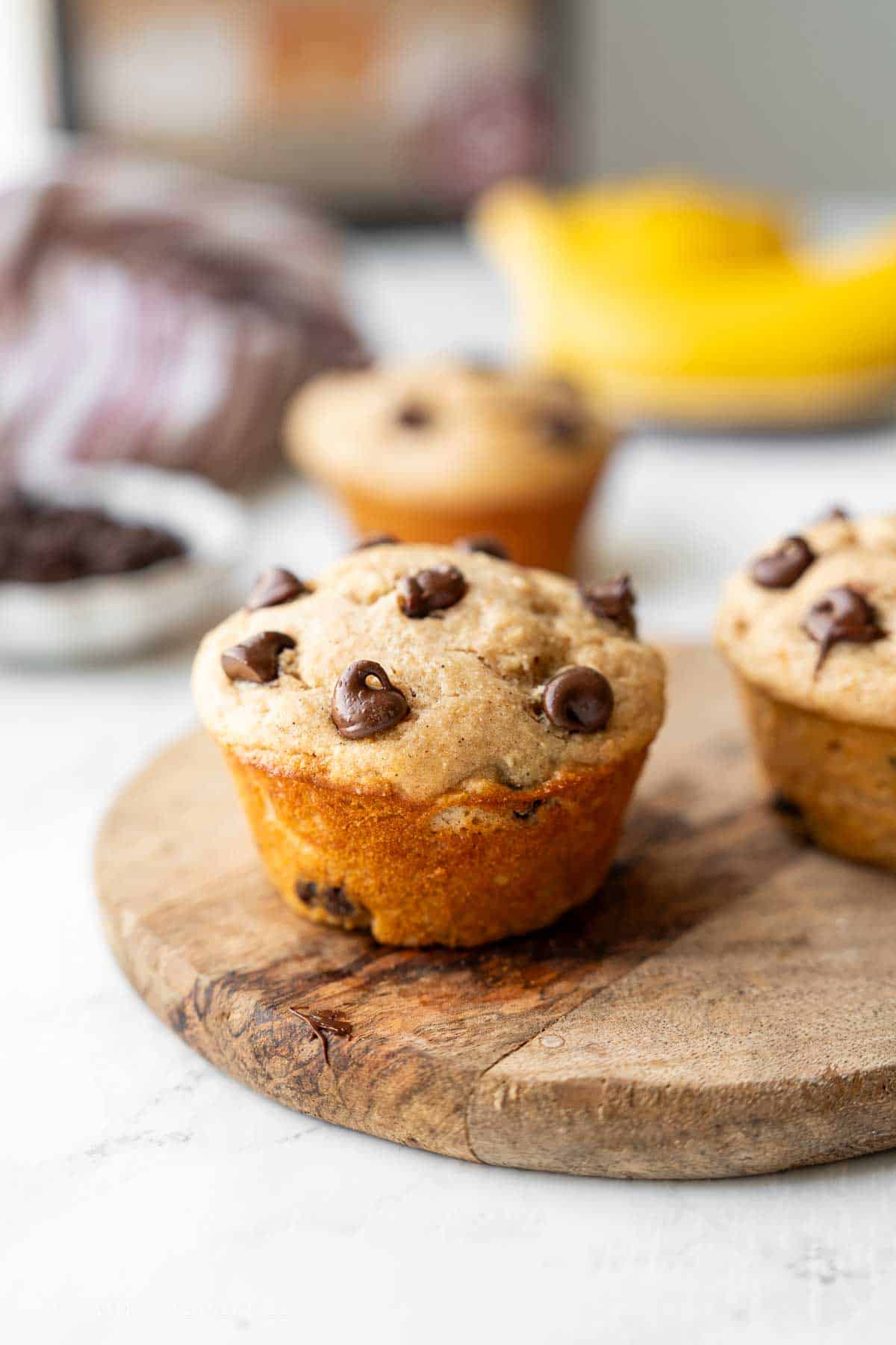 Baked banana protein muffin on cutting board.