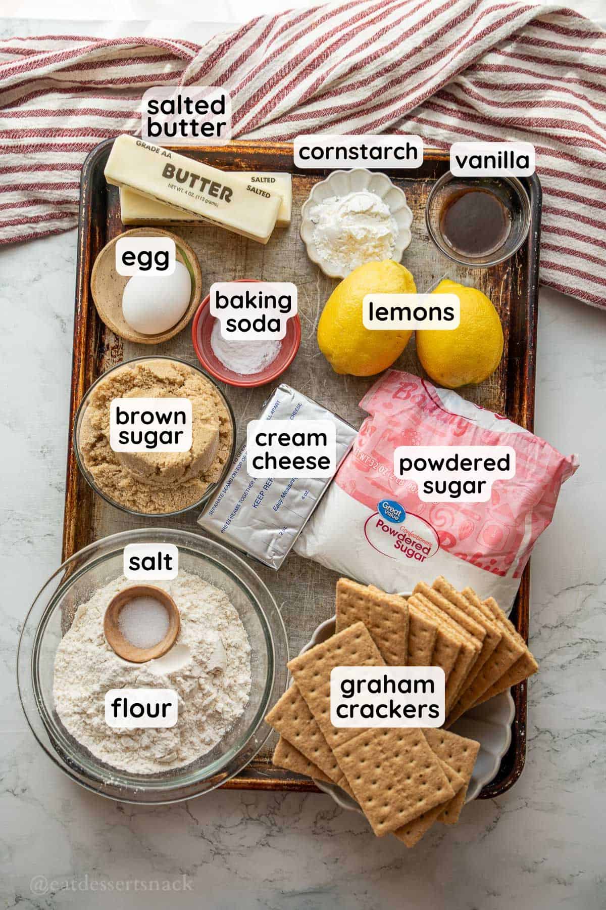 Labeled ingredients on metal tray for lemon cheesecake cookies.